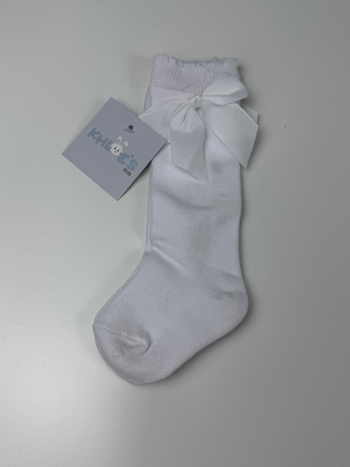 White sock with a bow and a tag on a gray background